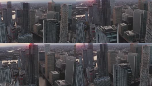幻灯片和平移镜头的未来城市地区。在日落时分，金丝雀码头的商业中心是高大的办公楼和公寓。英国伦敦高清在线视频素材下载