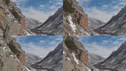 这是一幅鸟瞰图，在早春的时候，峡谷上的岩石被雪覆盖。高清在线视频素材下载