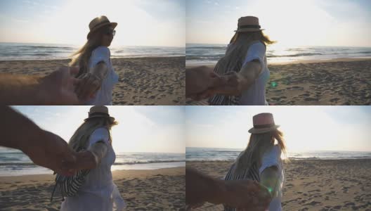 美丽的女孩在衬衫与背包牵着男性的手，在空旷的海滩上奔跑。跟着我拍的快乐的年轻女子戴着帽子拉着男友到海边。Summwe度假的概念。观点慢动作高清在线视频素材下载