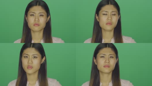 美丽的亚洲女人看起来失望，在绿色屏幕效果工作室背景高清在线视频素材下载