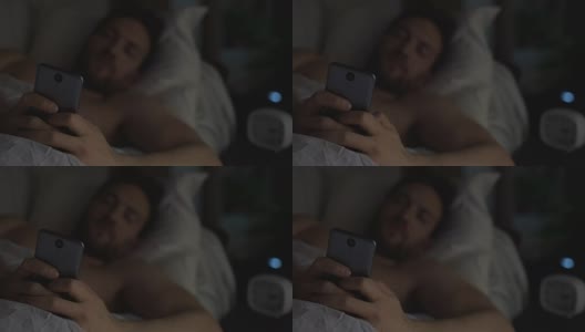 失眠的人睡不着，在床上刷手机，失眠高清在线视频素材下载