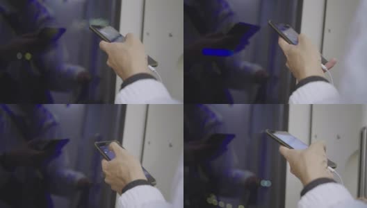 亚洲男子在火车上用智能手机使用社交媒体高清在线视频素材下载