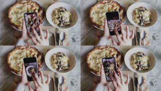 一名女博主用智能手机拍摄美食，在意大利餐厅拍意大利面和披萨，并在网上发布社交媒体生活方式高清在线视频素材下载