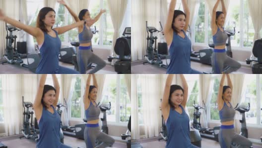 两位亚洲女性在运动服装训练和练习瑜伽教练为健康的生活方式。高清在线视频素材下载