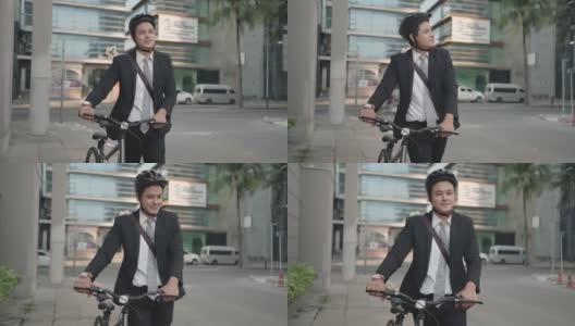 亚洲商人在早上推着他的自行车从家里准备骑他的自行车上班。生态交通运输。高清在线视频素材下载