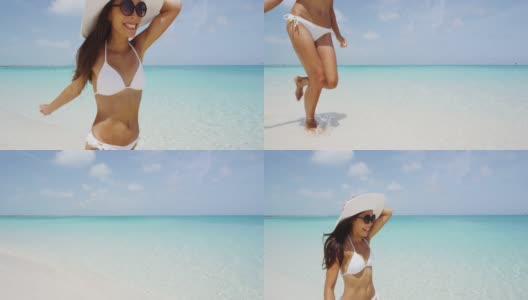 开朗的年轻女子穿着白色比基尼在沙滩上跑步。兴奋的女性尖叫的喜悦，在水里，戴着太阳镜和太阳帽享受大自然的暑假。田园诗般的完美的海滩。高清在线视频素材下载