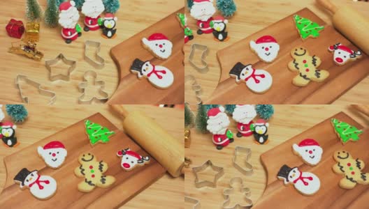 全景图:用奶油装饰的系列工具和自制的圣诞饼干、红鞋、雪人、姜饼、鹿头、圣诞树、圣诞老人脸。一些饼干包括糖衣圣诞老人和带圣诞帽的企鹅高清在线视频素材下载