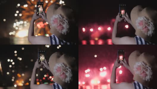 一名女子用手机拍烟花。剪影背景上的天空照亮了烟花高清在线视频素材下载