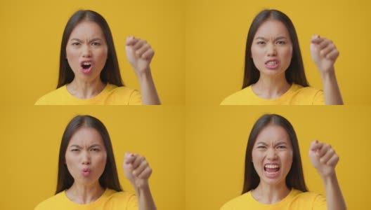 愤怒的韩国女性用手指指责某人，黄色背景高清在线视频素材下载