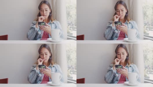 一个迷人的年轻女子坐在咖啡店里发短信的4k视频片段高清在线视频素材下载