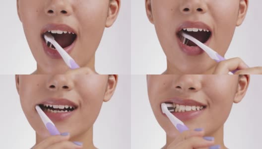 健康的习惯。近距离的年轻女子刷牙她完美的白牙齿，慢动作高清在线视频素材下载