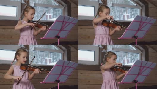 可爱的小女孩在阁楼练习小提琴高清在线视频素材下载