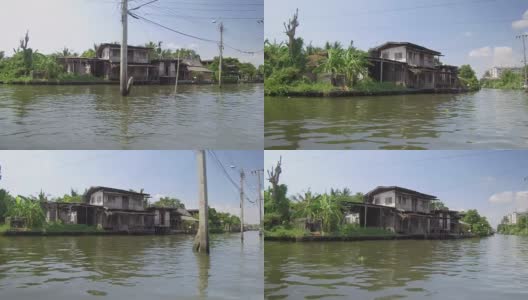 低角度:河边孤独的房子在河边的烈日下慢慢腐烂。高清在线视频素材下载