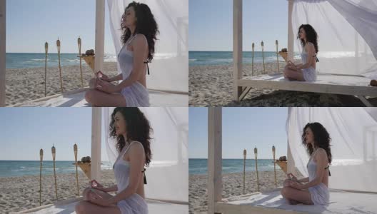 暑假，女孩在海边深呼吸，女人在海边冥想，女人在堤岸做瑜伽高清在线视频素材下载