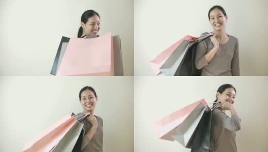 年轻快乐的亚洲女孩拿着很多购物袋高清在线视频素材下载