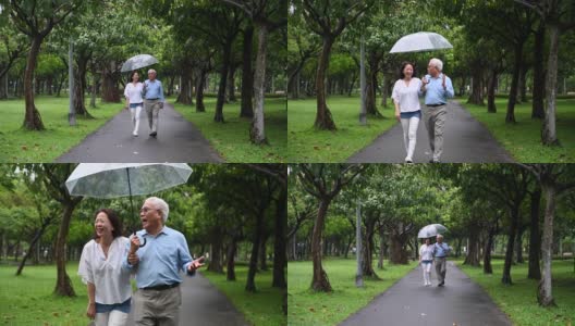 快乐的老年夫妇一起走在雨中高清在线视频素材下载