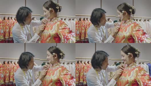 男中国婚纱设计师在工作室试穿年轻新娘高清在线视频素材下载