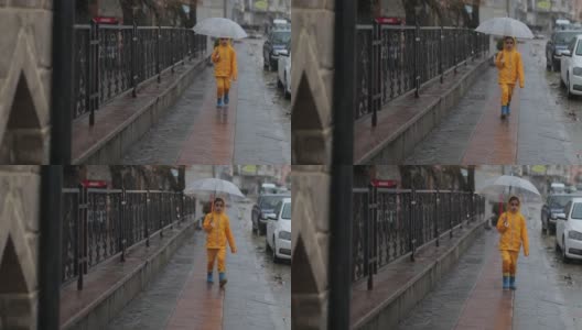 小女孩打着伞在雨中走高清在线视频素材下载