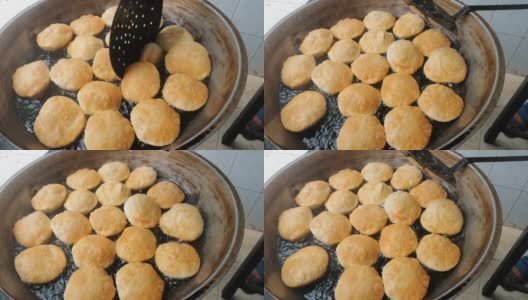 用热油制作当地街头小吃puri。制作美味的孟加拉Luchi或油炸面包。它也被称为印度穷人。高清在线视频素材下载