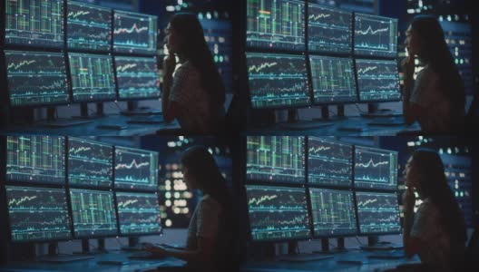 金融分析师的肖像工作在计算机与多显示器工作站与实时股票，商品和交易市场图表。在投资经纪公司工作的女商人。高清在线视频素材下载