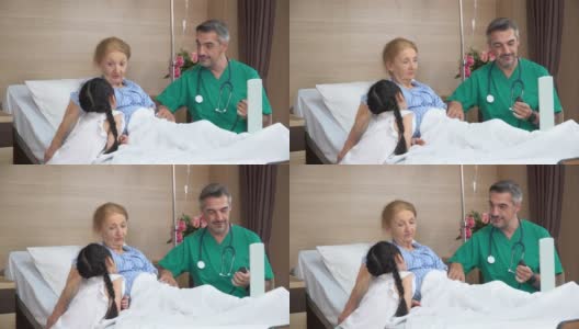 在病房里，医生正和躺在床上陪孙女的老年女病人交谈。物理治疗师探访及与残疾老年女性进行物理治疗。高清在线视频素材下载
