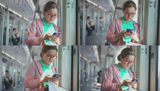年轻女子在乘坐地铁时使用智能手机高清在线视频素材下载