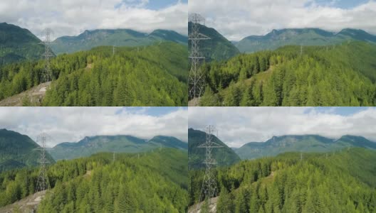 电力塔将电力传输到山林之上的城市高清在线视频素材下载