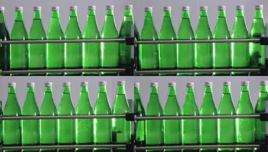 绿色矿泉水瓶沿着自动生产线移动。高清在线视频素材下载