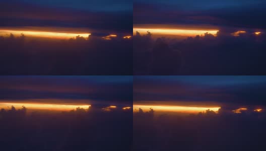 复制空间:蓬松的云朵和紫色的天空掩盖了风景如画的橙色日出。高清在线视频素材下载