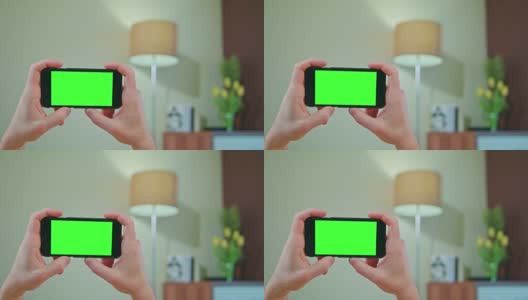 男性手持绿色屏幕的手机高清在线视频素材下载