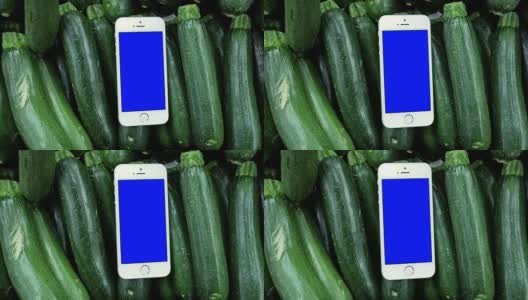 移动蓝屏手机上的西葫芦背景烹饪食谱的概念高清在线视频素材下载