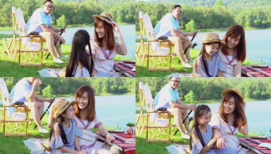 4K快乐的年轻亚洲家庭享受露营在湖。两位父母和可爱的小女孩一家人坐在帐篷前的露营椅上钓鱼和玩得一起在假期。高清在线视频素材下载
