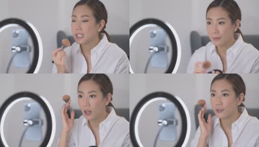 一位美丽的亚洲化妆博主正在家中直播如何化妆高清在线视频素材下载