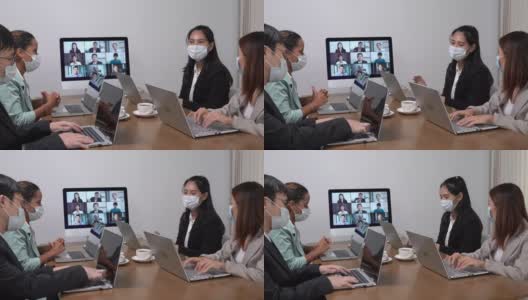 年轻的亚洲员工和资深的办公室员工团队通过电脑进行Zoom视频电话会议，商务人士共用办公桌使用电脑共同工作高清在线视频素材下载