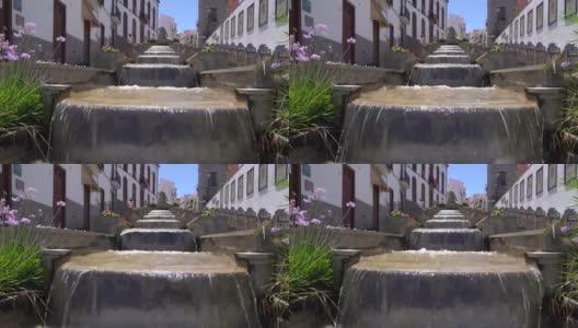 慢镜头大喷泉与连续瀑布运行的水沿街道。Firgas大加那利岛。高清在线视频素材下载