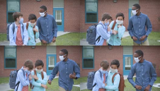 三个中学生戴着面具在户外散步聊天高清在线视频素材下载