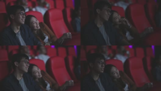 亚洲华人年轻夫妇喜欢在电影院看电影高清在线视频素材下载