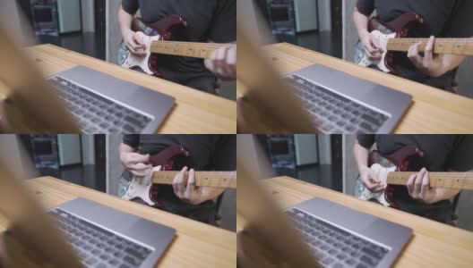 50Fps，一个摇滚音乐家通过互联网上的在线免费和弦练习他的电子吉他技能，使用数字笔记本电脑，社交媒体在线娱乐姿势，直播，硬技能提高高清在线视频素材下载
