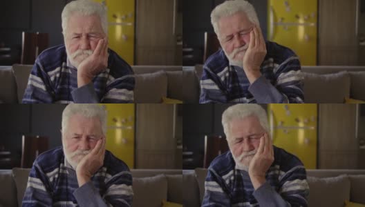 一位老人正在忍受牙痛。肖像高清在线视频素材下载