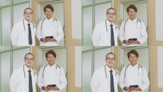 两位成功的医生在医院对着镜头微笑高清在线视频素材下载