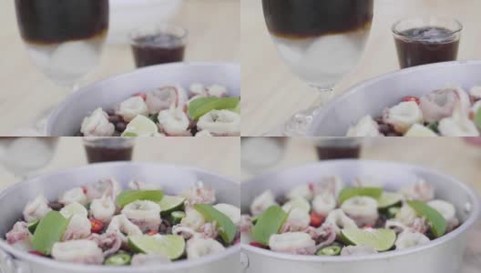 鱿鱼用咖啡豆和香草装饰，鱿鱼放在咖啡豆上放在一个钢碗里高清在线视频素材下载
