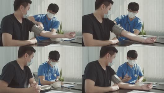 一名亚洲医生在做年度检查时使用病人的血压监测器，并解释他的血压。高清在线视频素材下载