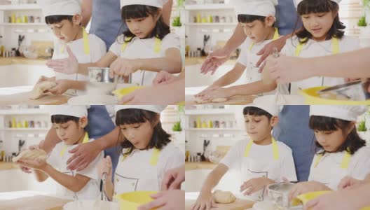 快乐微笑的年轻亚洲日本家庭与学龄前的孩子有乐趣在现代厨房家庭的早餐烘焙糕点或派。高清在线视频素材下载
