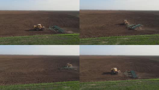 拖拉机用耙子在地里干活，转身离开了。松动地面，保护土壤，平整其表面，准备种植小麦和消灭杂草，无人机射击高清在线视频素材下载