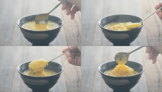 用勺子搅拌和舀粥高清在线视频素材下载