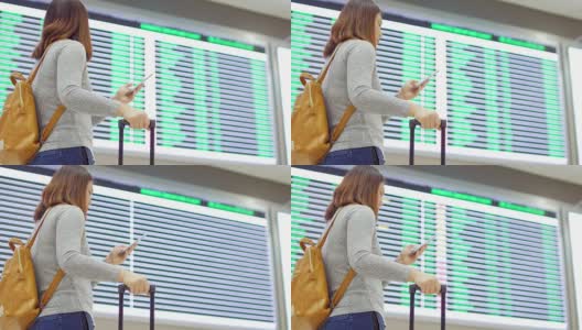 一名女乘客在离港机场办理登机手续前，用手机在数字登机牌上检查她的航班高清在线视频素材下载