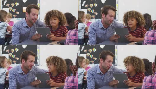 老师和小男生在课堂上使用平板电脑高清在线视频素材下载