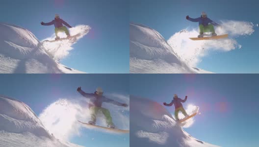 慢动作:专业滑雪板运动员在新雪中跳跃，向太阳喷洒雪花高清在线视频素材下载