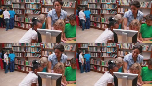 学生和老师在图书馆看电脑高清在线视频素材下载