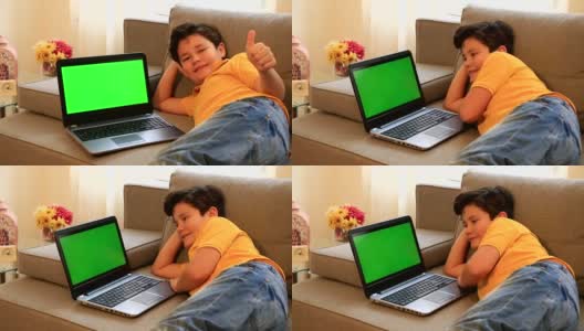 孩子用绿色屏幕的笔记本电脑显示器高清在线视频素材下载